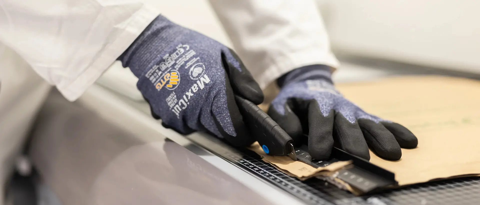 A photo of cardboard being cut.