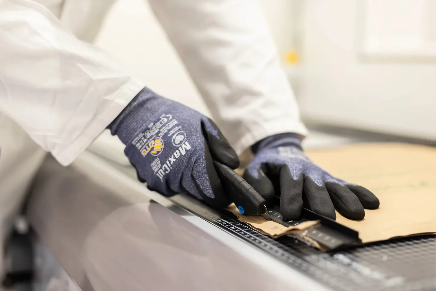 A photo of cardboard being cut.